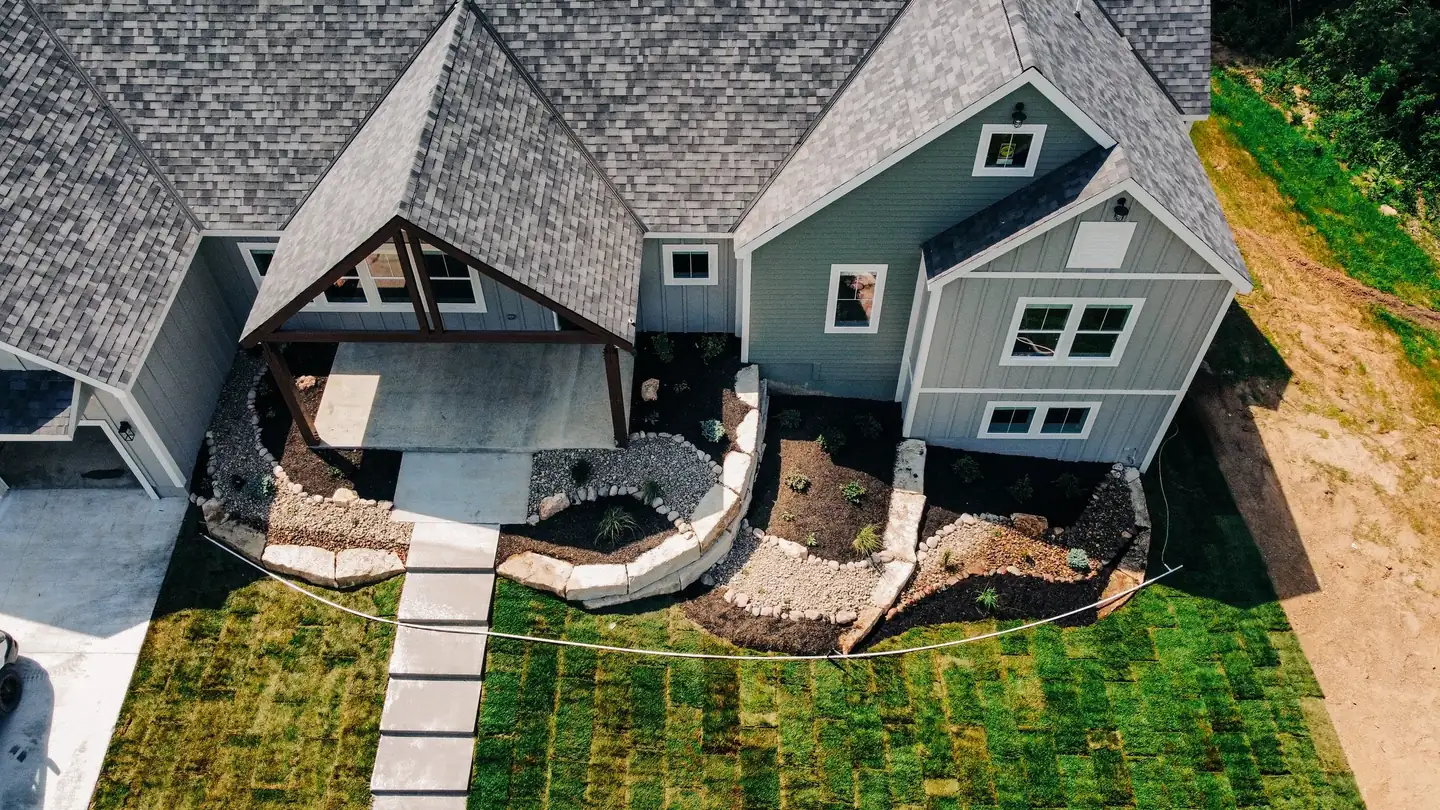 Aerial view of a home surrounded by mature trees
