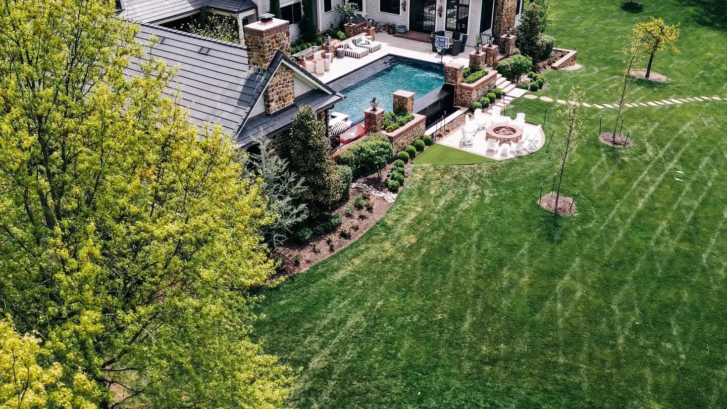 Aerial view of a large residential property and its tree cover